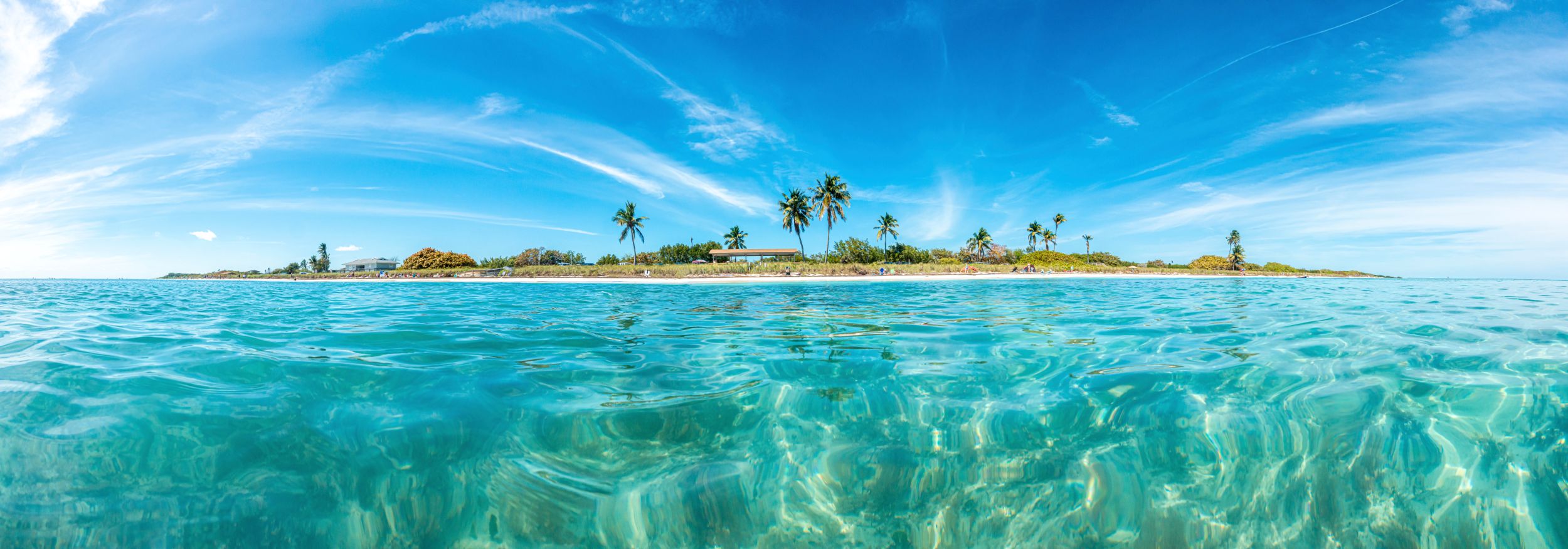 Palm-lined key surrounded by clear turquoise water